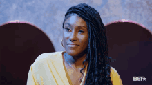 a woman with dreadlocks and a bet logo in the corner