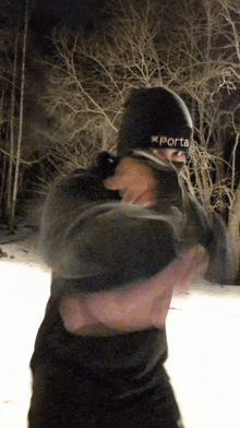 a person wearing a black beanie that says porta