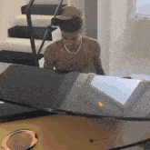 a shirtless man is standing in front of a piano that says columbia