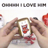 a person is holding a piece of bread with a face on it and the words " ohhhh i love him " above it