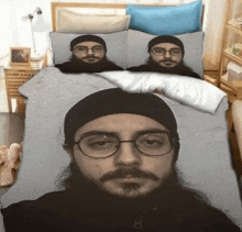 a man with glasses and a beard is on a bed