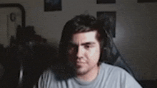 a man wearing headphones is making a funny face in a blurry photo .
