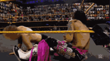 a pixel art of a wrestling match with a w logo