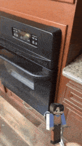 a black stove top oven with a minecraft character standing next to it