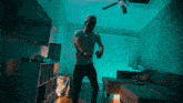 a man dancing in a living room with blue lights
