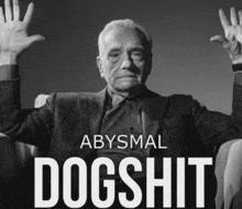 a poster for abysmal dogshit shows an older man with his hands up