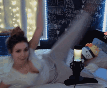 a woman laying on a bed in front of a chalkboard that says subs on it