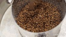 a strainer filled with brown grains has the words made in animatica on the bottom