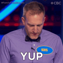 a man wearing a purple shirt and bow tie says yup