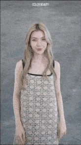 a woman in a dress with the word color beauty on the bottom right