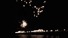 a fireworks display over a body of water at night