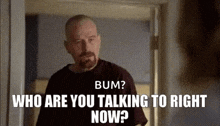 a man with a beard is talking to another man in a room .