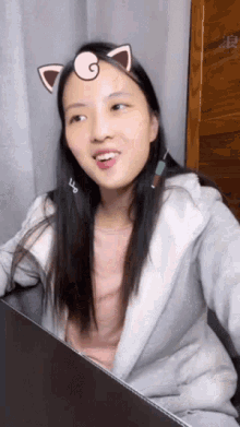 a woman wearing a cat ear sticker on her face