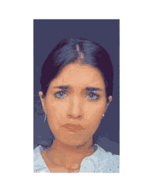 a close up of a woman 's face with a sad look on her face
