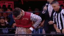 a wrestler wearing a shirt that says 2024