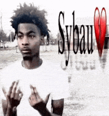 a man in a white shirt is standing in front of a broken heart .