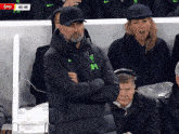 a man wearing a jacket that says ' liverpool ' on the front