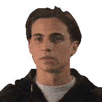 a young man wearing a white t-shirt and a brown jacket looks at the camera