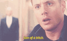 a man is saying son of a bitch in a blurry photo .