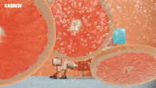 a woman sits on a couch in front of an orange wall with kabrew written on it