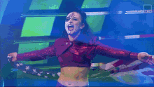 a woman in a red crop top holds an american flag