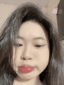 a close up of a woman 's face with a pink lip