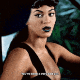 a woman in a black dress is saying you 've been a very bad girl