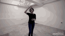 a woman in a black shirt is standing in an empty room with the words made in animotica on the bottom