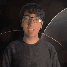 a man wearing glasses and a black shirt that says dean on it