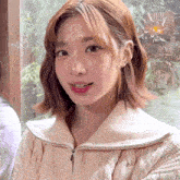 a close up of a woman wearing a sweater with a zipper on it