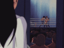 two men are boxing in a ring and a woman is watching