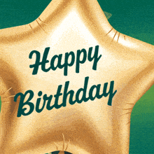 a gold star shaped balloon with the words happy birthday on it