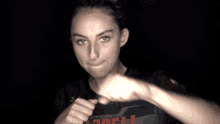 a blurry picture of a woman 's face and fist with the letter l visible