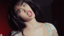a close up of a woman with red lips making a funny face