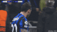 a soccer player wearing a blue jersey with the number 20 on the back