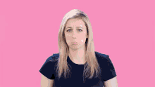 a woman in a blue shirt is making a funny face .