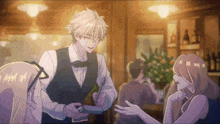 a man in a vest and bow tie is talking to a woman in a restaurant