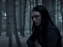 a woman is holding a bow and arrow in a dark forest with justjaycee tumblr in the upper right corner