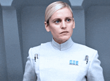 a woman in a white uniform has a badge on her chest that says ' commander '