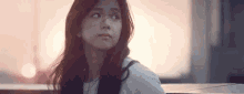 a close up of a woman 's face looking at the camera .
