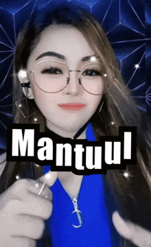 a woman wearing glasses and a blue shirt has the word mantuul written on her face