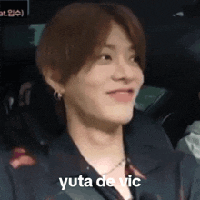 a close up of a person 's face with the words yuta de vic on it