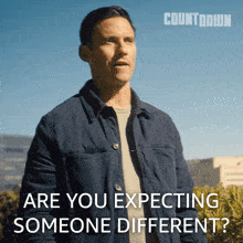a man stands in front of a sign that says countdown