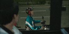 a person riding a motorcycle with a helmet on