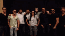 a group of people posing for a photo with a woman in the middle