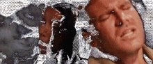 a pixelated image of a man with his eyes closed and a woman behind him