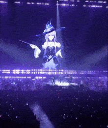 a woman in a witch costume is projected on a large screen