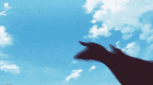 a silhouette of a person pointing at a blue sky with clouds