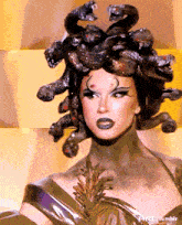 a woman in a medusa costume with snakes on her hair