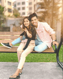 a boy and a girl are sitting on a bench together